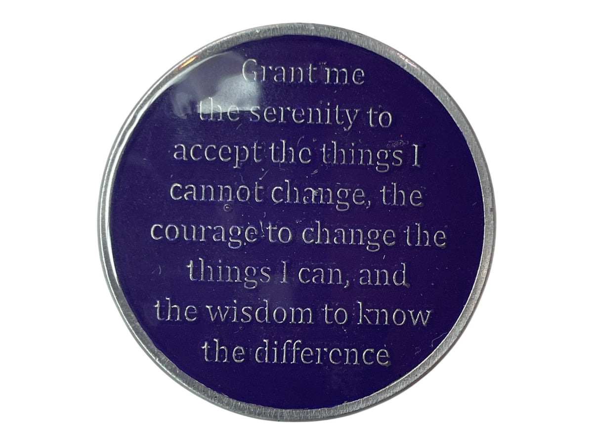 A round, silver-colored token with a dark purple background. The token has the following text engraved in white: 'Grant me the serenity to accept the things I cannot change, the courage to change the things I can, and the wisdom to know the difference.'