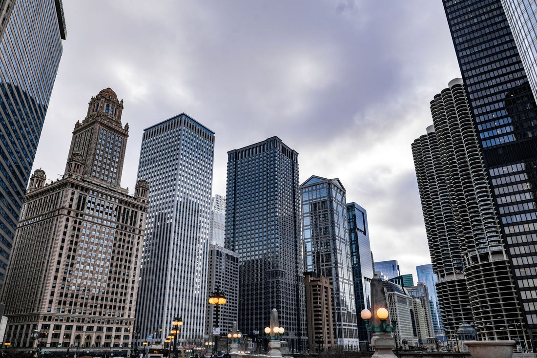 Downtown Chicago skyline beneath a dramatic winter sky with historic and modern high-rise buildings.