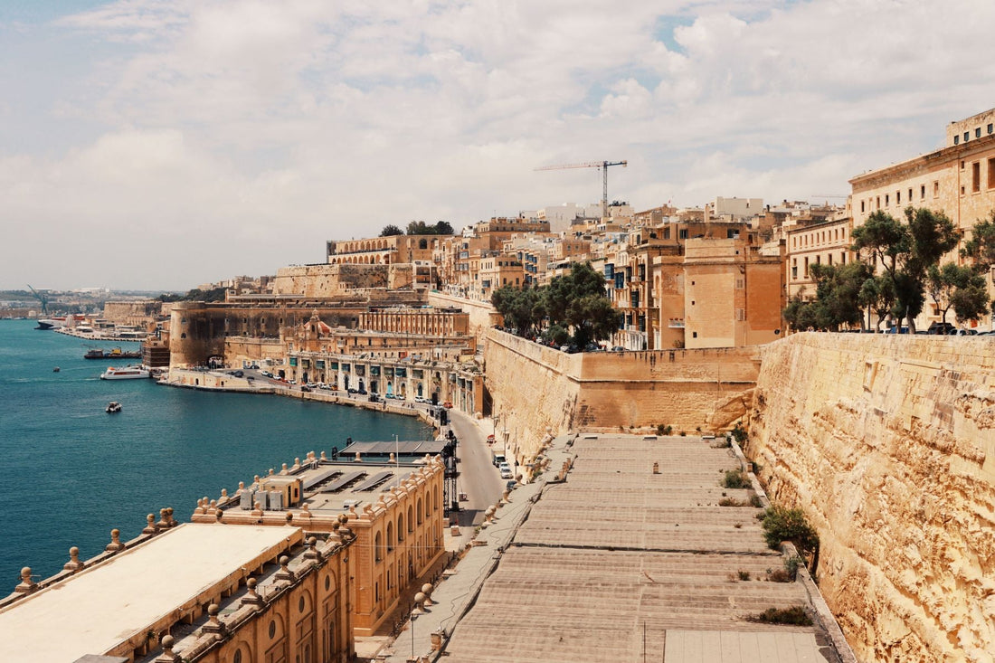Valletta's historic limestone fortifications and waterfront overlooking the blue waters of Malta's Grand Harbour.