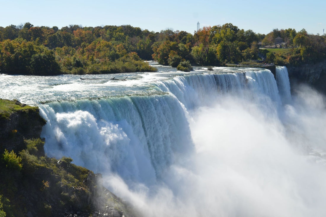 Niagara Falls surrounded by early autumn foliage in Niagara Falls, New York