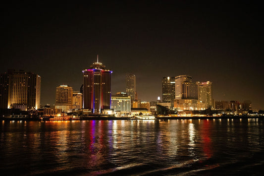 New Orleans skyline at night reflected on the Mississippi River