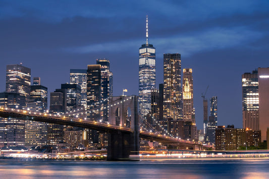 Brooklyn Bridge and the Manhattan skyline at dusk in New York City.