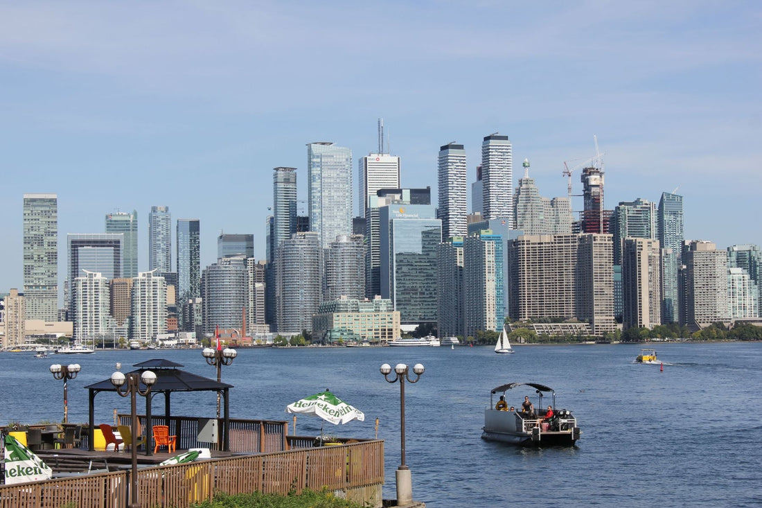 Toronto waterfront with boats on Lake Ontario and the downtown skyline in the background.