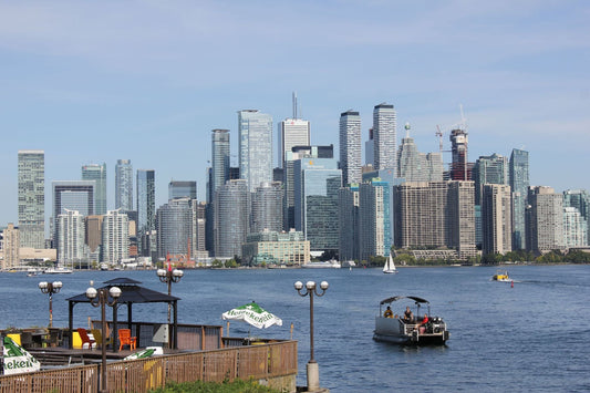 Toronto waterfront with boats on Lake Ontario and the downtown skyline in the background.