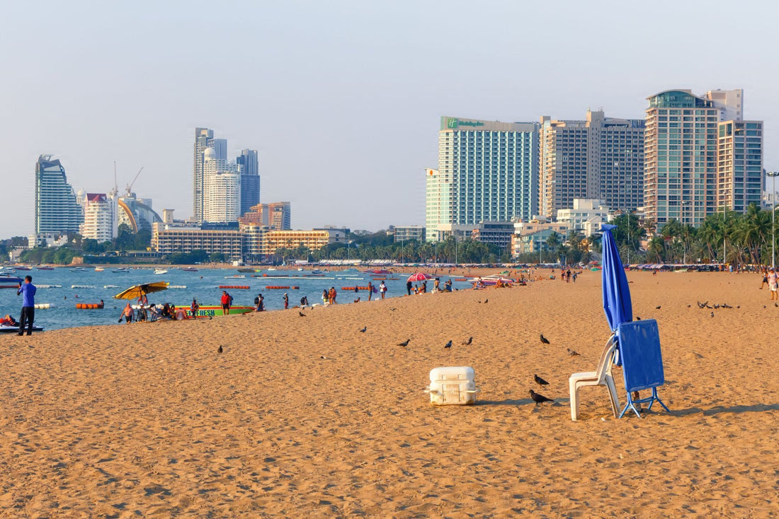 Pattaya Beach with Gulf of Thailand water, sandy shoreline and high-rise buildings along the beachfront.