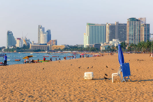 Pattaya Beach with Gulf of Thailand water, sandy shoreline and high-rise buildings along the beachfront.