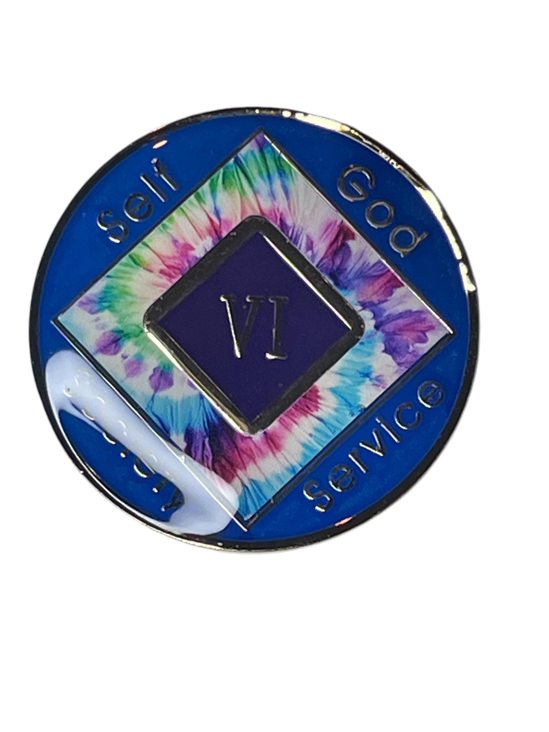 Narcotics Anonymous 6-year recovery medallion with vibrant tie-dye design symbolizing unity and spiritual growth, featuring metallic blue edges and engraved words “Self, God, Society, Service” with Roman numeral VI in the center.