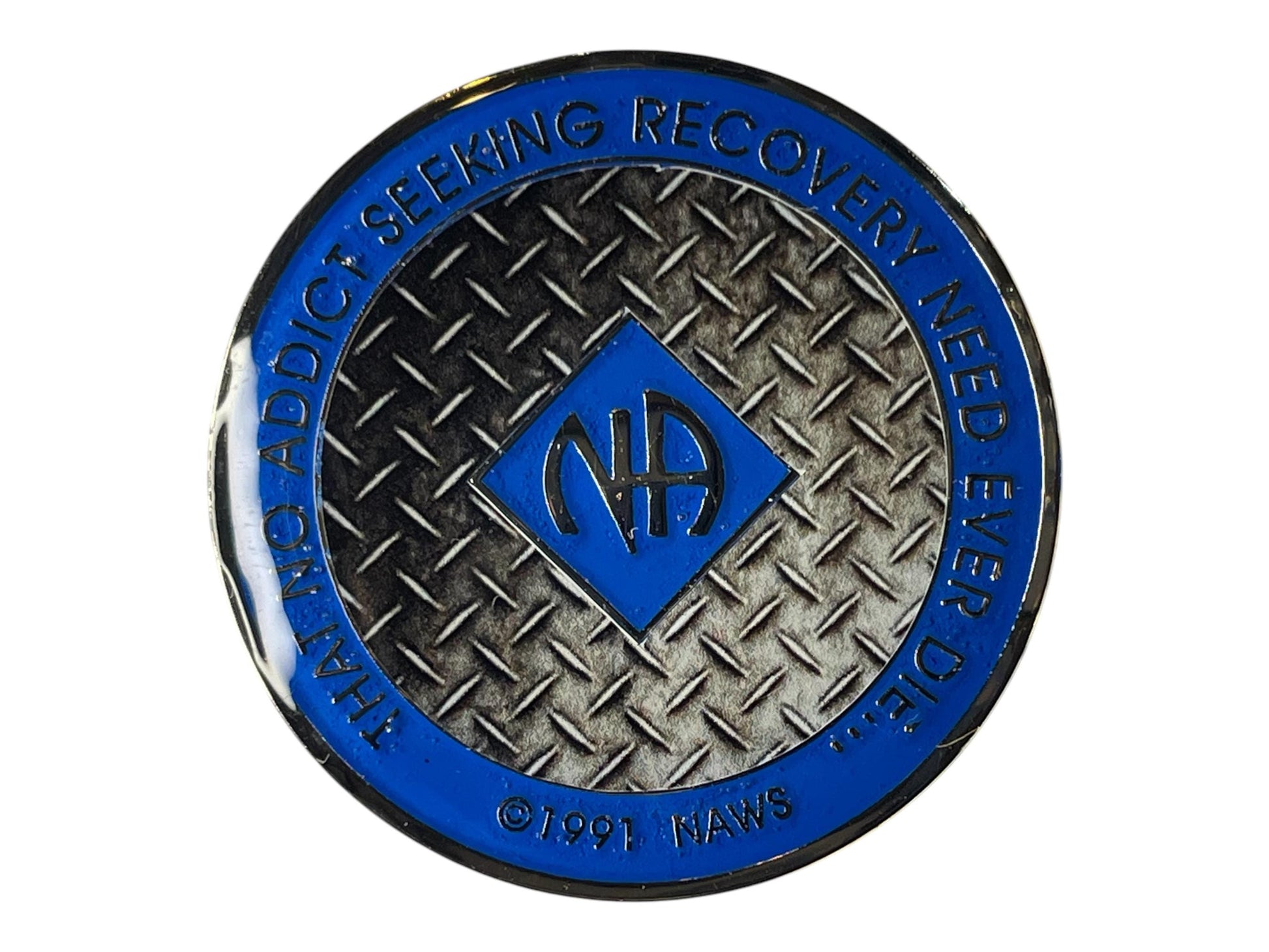 Narcotics Anonymous recovery medallion featuring a blue enamel border and diamond plate steel texture background. The NA logo is centered with the inscription “That No Addict Seeking Recovery Need Ever Die,” symbolizing perseverance, inner strength, and the resilience of recovery.