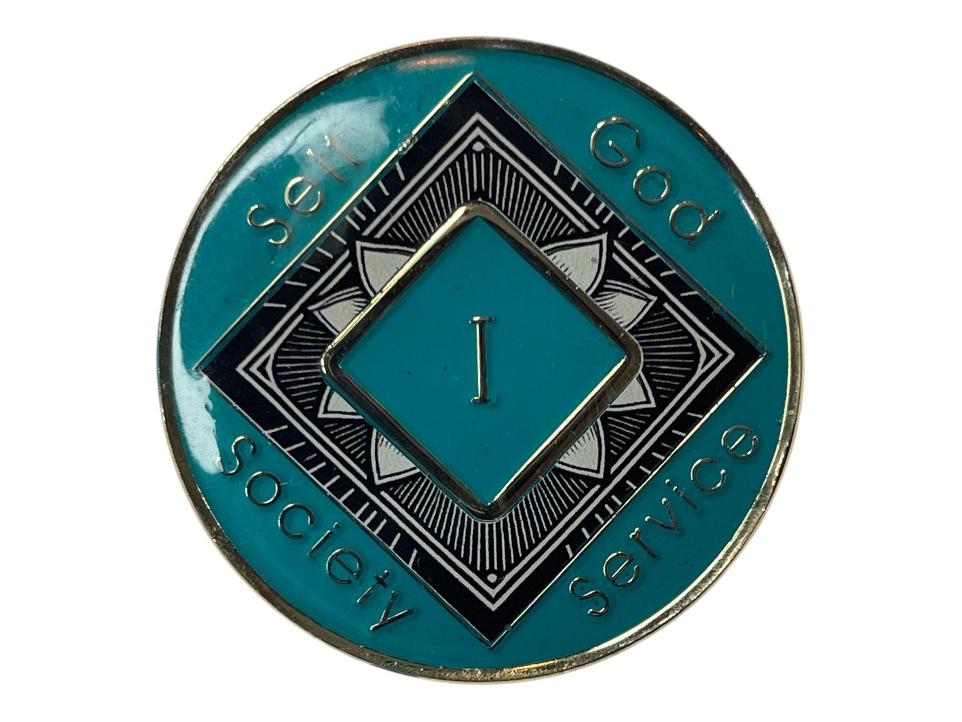 Narcotics Anonymous teal 1-year recovery medallion featuring a black and white lotus flower design symbolizing renewal and spiritual awakening, with “Self, God, Society, Service” engraved around the border to represent balance and growth in sobriety.