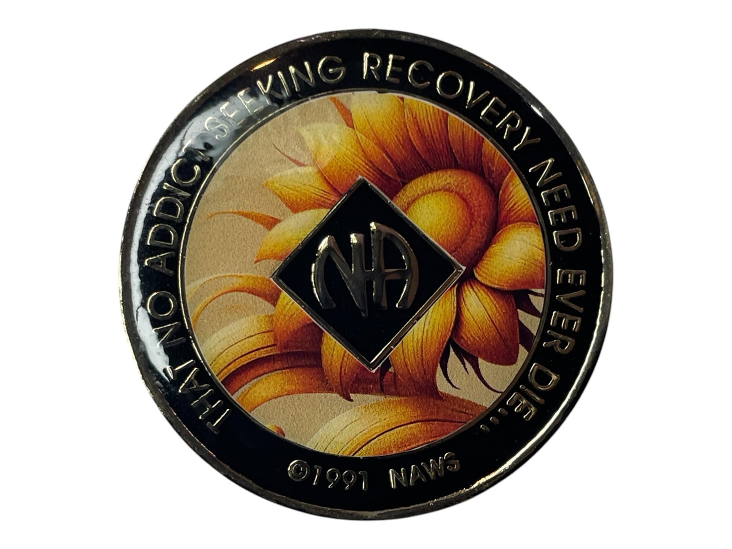 Narcotics Anonymous recovery medallion featuring a golden sunflower background symbolizing growth, hope, and a new beginning in recovery. The NA logo sits at the center within a black diamond, surrounded by a glossy black border inscribed with “That No Addict Seeking Recovery Need Ever Die,” representing unity, healing, and the light of recovery.