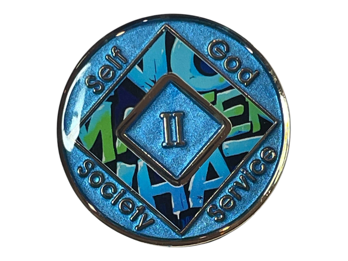 Blue Narcotics Anonymous recovery medallion with a diamond center showing the Roman numeral II. Surrounding words read ‘Self,’ ‘God,’ ‘Society,’ and ‘Service,’ with graffiti-style text ‘No Matter What’ in the background.