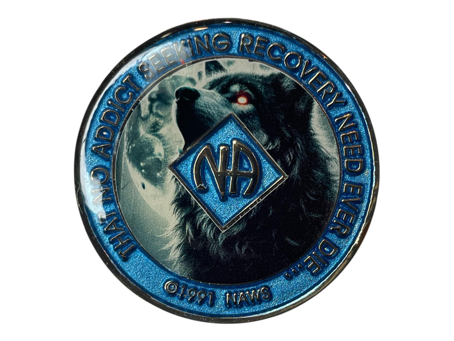 Narcotics Anonymous recovery medallion featuring a powerful black wolf with glowing red eyes howling at the moon, symbolizing strength, transformation, and the fight for freedom in recovery. The medallion has a shimmering metallic blue border engraved with “That No Addict Seeking Recovery Need Ever Die,” and the NA logo centered over the wolf, representing courage, perseverance, and spiritual awakening.