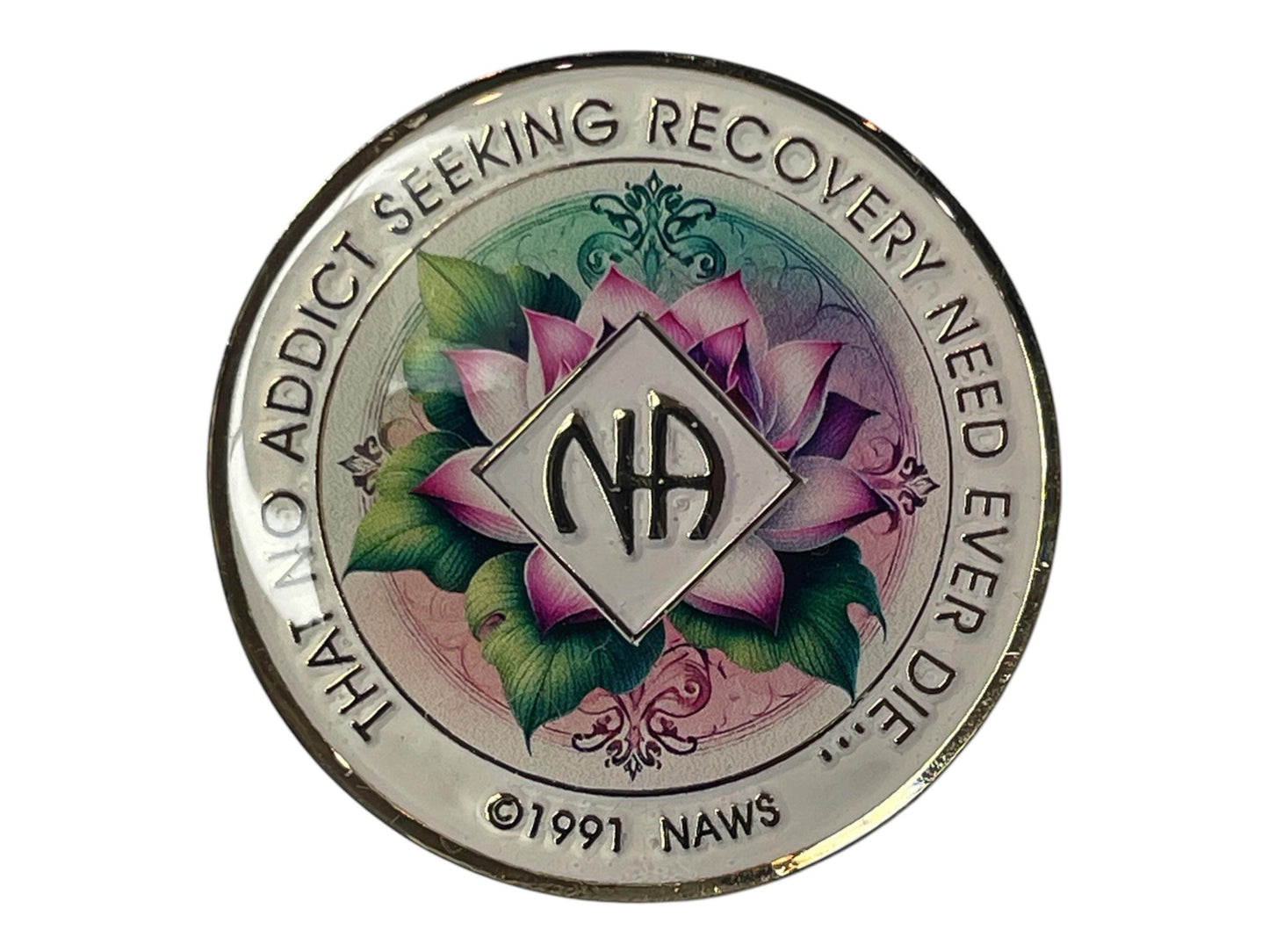 Narcotics Anonymous recovery medallion featuring a beautifully detailed lotus flower design symbolizing rebirth, purity, and spiritual awakening. The medallion has a soft gradient background of pastel green and pink tones, with the NA logo in the center and the message “That No Addict Seeking Recovery Need Ever Die” engraved around the border, representing hope and serenity in recovery.