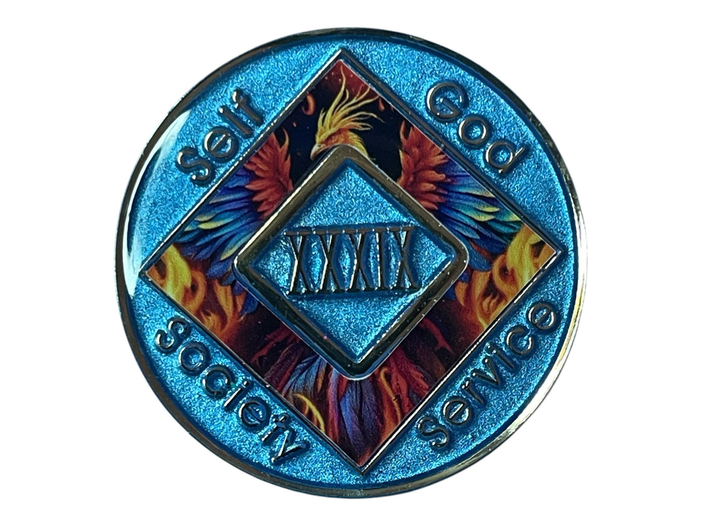 Narcotics Anonymous 39-year sobriety medallion with shimmering blue border, fiery phoenix artwork, and the words Self, God, Society, Service surrounding the Roman numeral XXXIX