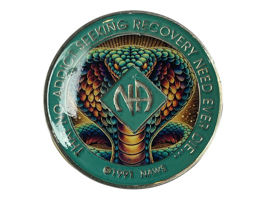 Narcotics Anonymous cobra medallion featuring a detailed, colorful snake design with teal border and NA logo in the center, surrounded by the phrase “That No Addict Seeking Recovery Need Ever Die,” symbolizing transformation, strength, and rebirth in recovery.