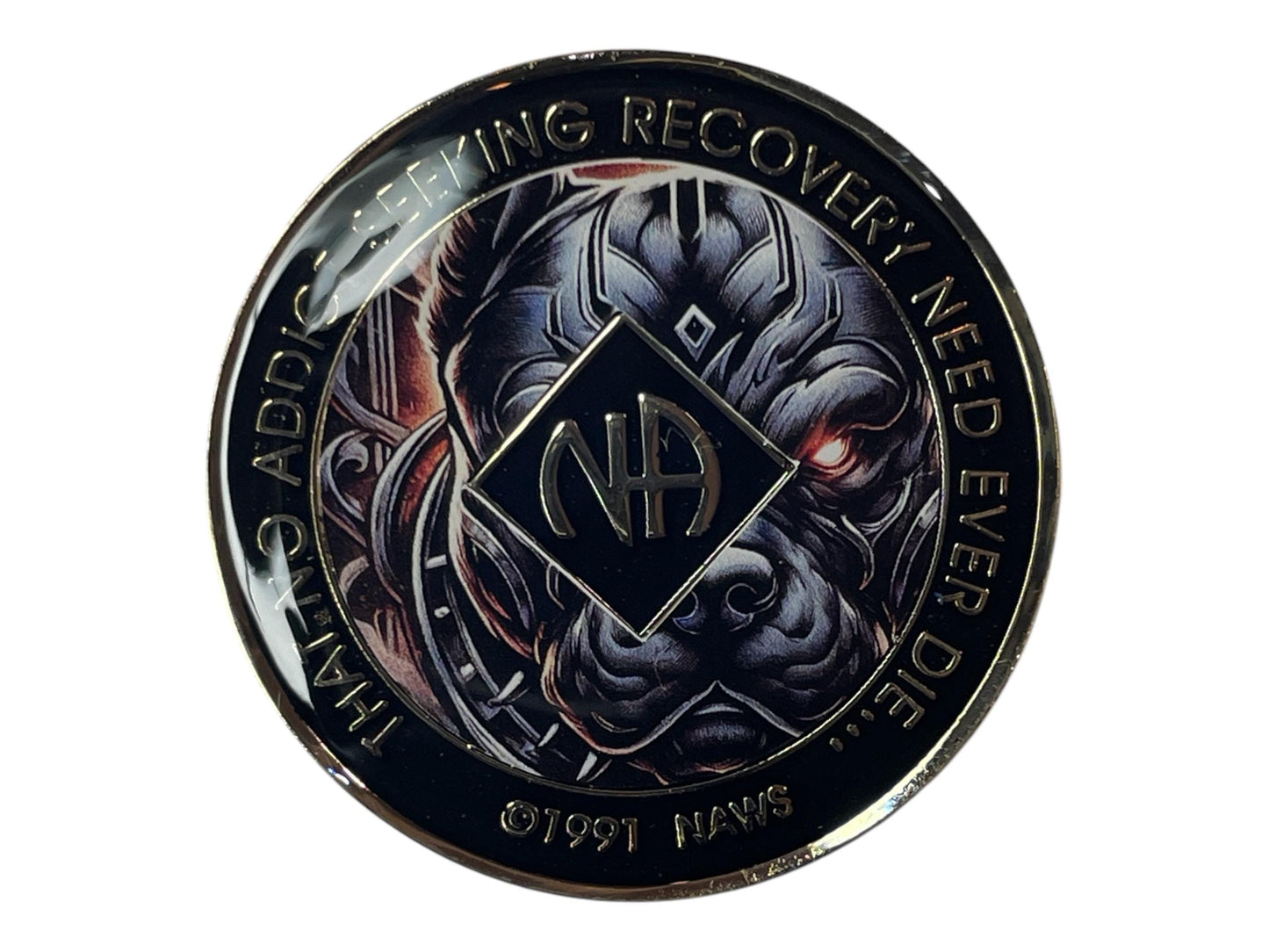Narcotics Anonymous recovery medallion with black border, NA diamond logo, and fierce dog artwork, featuring the phrase ‘That No Addict Seeking Recovery Need Ever Die.’