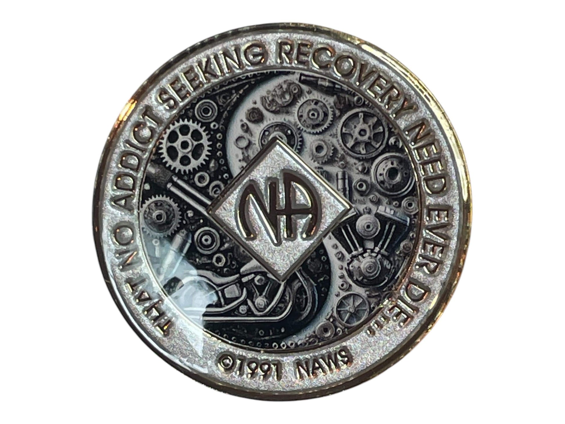 Narcotics Anonymous silver recovery medallion featuring intricate black and chrome mechanical gears and motorcycle artwork with NA logo and quote ‘That no addict seeking recovery need ever die,’ symbolizing strength, perseverance, and unity in recovery.