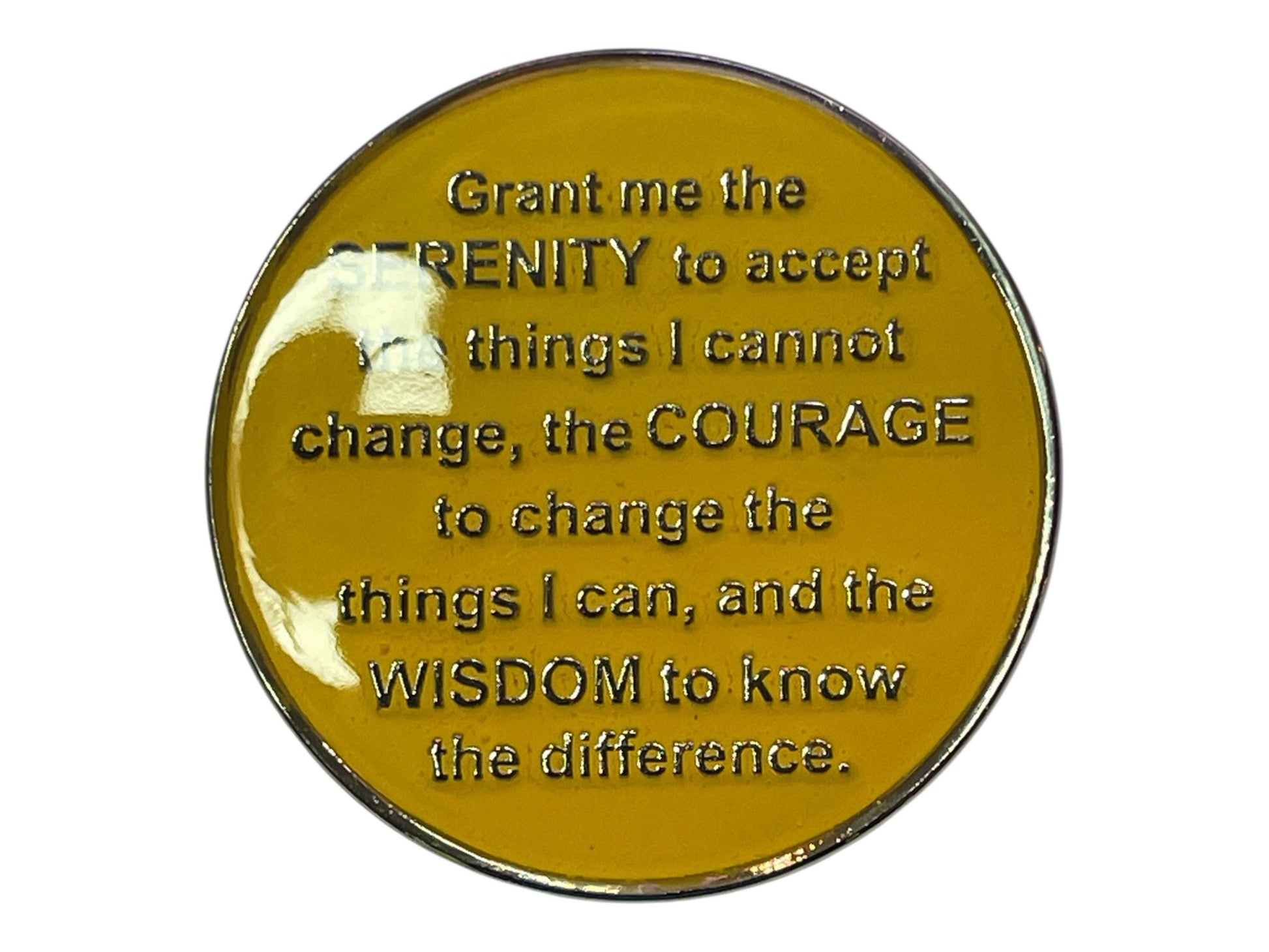 Yellow AA medallion engraved with the Serenity Prayer: “Grant me the serenity to accept the things I cannot change, the courage to change the things I can, and the wisdom to know the difference.” A symbol of peace, strength, and spiritual growth in recovery.