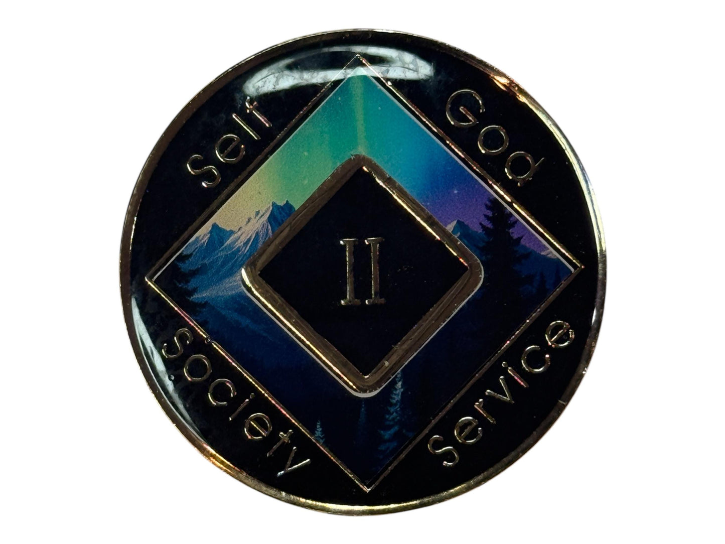 Narcotics Anonymous 2-year recovery medallion featuring a serene aurora borealis scene over snow-capped mountains and evergreen trees, symbolizing guidance, peace, and spiritual growth. The medallion has a black metallic border engraved with “Self, God, Society, Service,” and a central diamond displaying the Roman numeral II, representing two years clean and a journey illuminated by hope and faith.