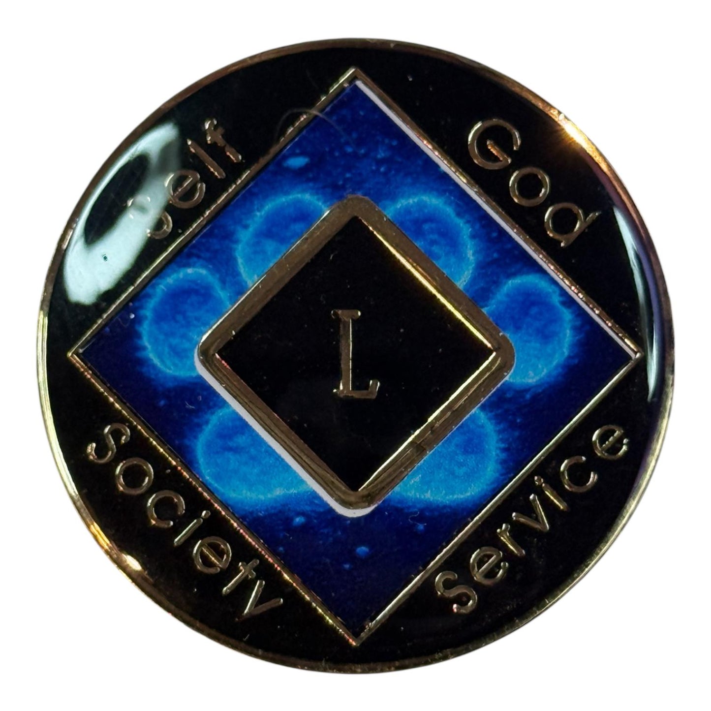 Narcotics Anonymous blue recovery medallion featuring a glowing paw print design with the Roman numeral L for 50 years clean, symbolizing strength, loyalty, and spiritual growth in addiction recovery.