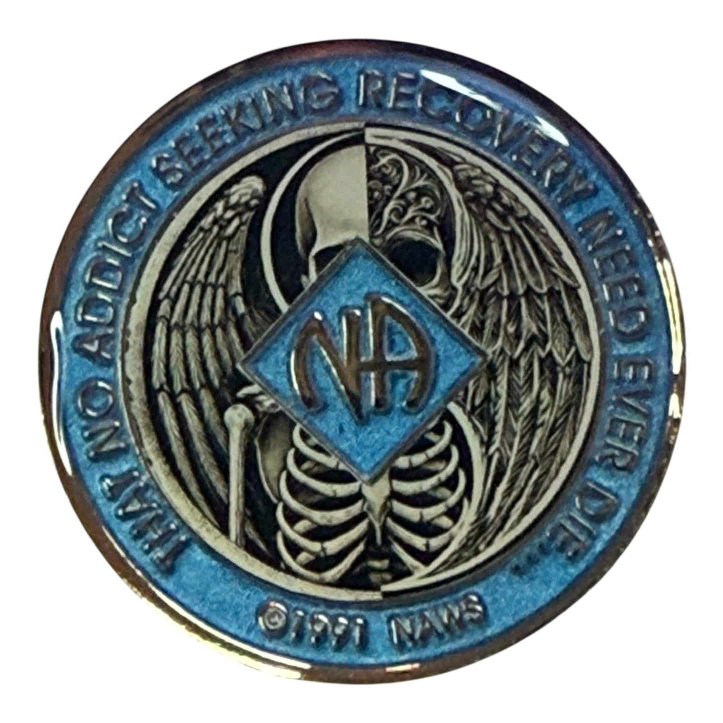 Narcotics Anonymous recovery medallion featuring a striking angel and reaper design symbolizing the balance between life, death, and rebirth in recovery. The medallion has a metallic blue border engraved with “That No Addict Seeking Recovery Need Ever Die,” and the NA logo centered between angel wings and skeletal ribs, representing transformation, redemption, and spiritual awakening.
