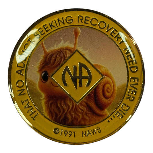 Narcotics Anonymous recovery medallion with golden border and NA symbol in the center, featuring a cute fuzzy snail illustration in the background and the phrase ‘That no addict seeking recovery need ever die.’