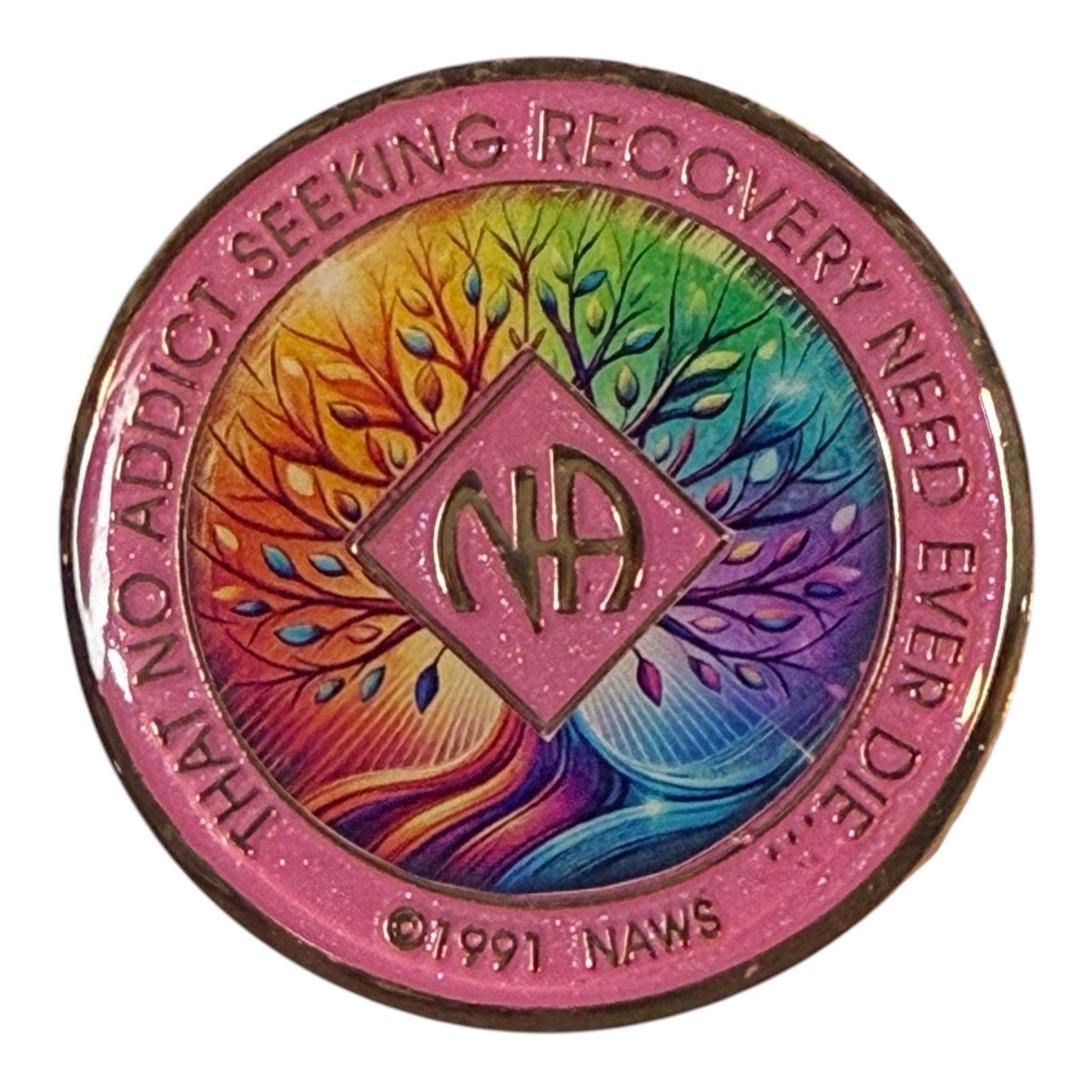 Narcotics Anonymous recovery medallion featuring a pink border and a vibrant rainbow Tree of Life design symbolizing growth, unity, and healing in recovery, with the NA logo and the phrase ‘That No Addict Seeking Recovery Need Ever Die.’