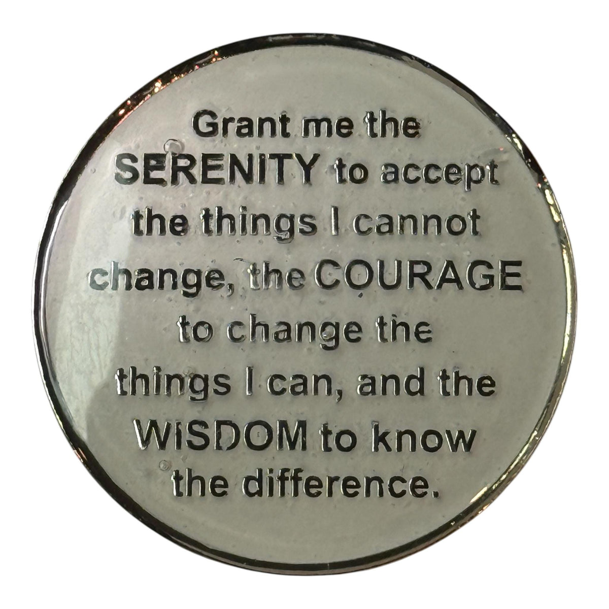 Reverse side of an Alcoholics Anonymous medallion engraved with the Serenity Prayer: “Grant me the serenity to accept the things I cannot change, the courage to change the things I can, and the wisdom to know the difference.” The polished silver surface reflects calmness and strength, symbolizing peace, courage, and spiritual growth in recovery.